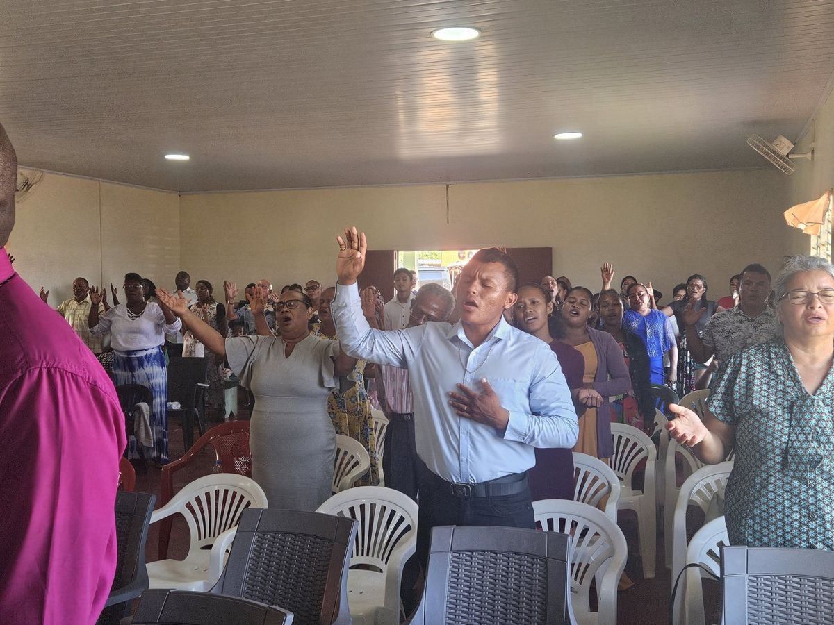The congregation worshipping with hands raised
