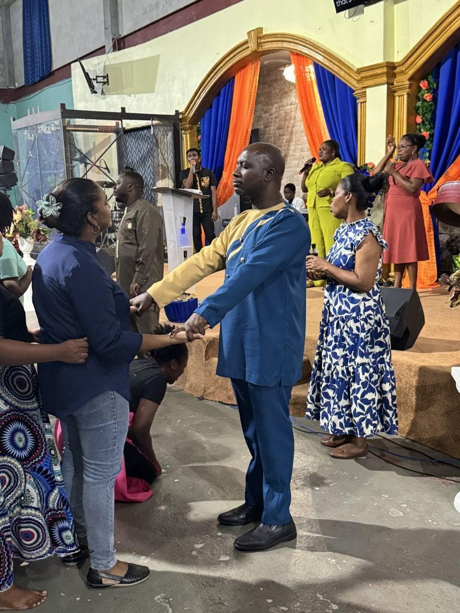 Apostle Lambert praying with people at the altar